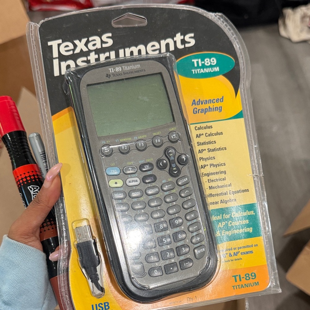 Texas Instruments TI-89 Titanium Graphing Calculator in Black and Gray Packaging